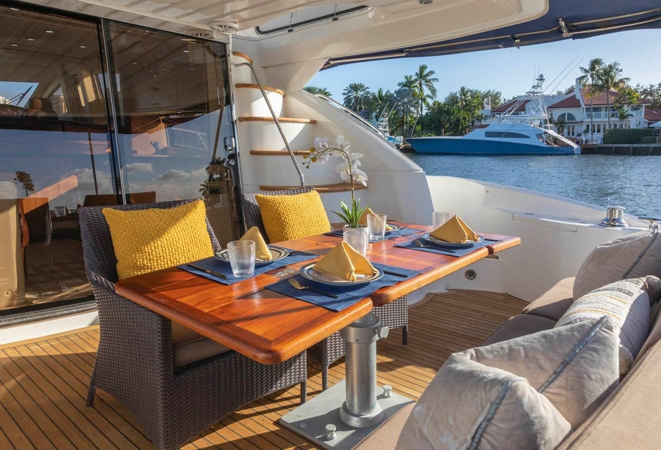 a table with chairs on it aboard UNFORGETTABLE Yacht for Sale