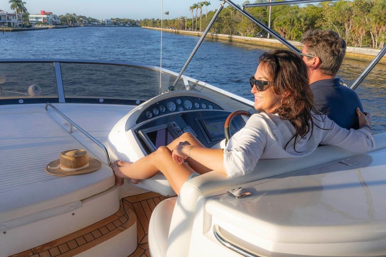 a man and woman in a boat aboard UNFORGETTABLE Yacht for Sale
