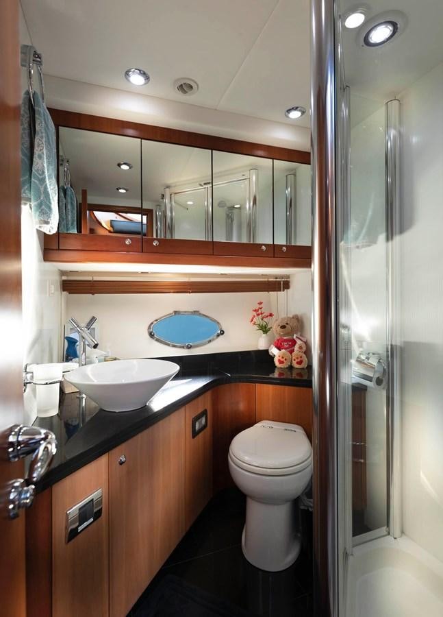 a bathroom with a glass shower door aboard UNFORGETTABLE Yacht for Sale