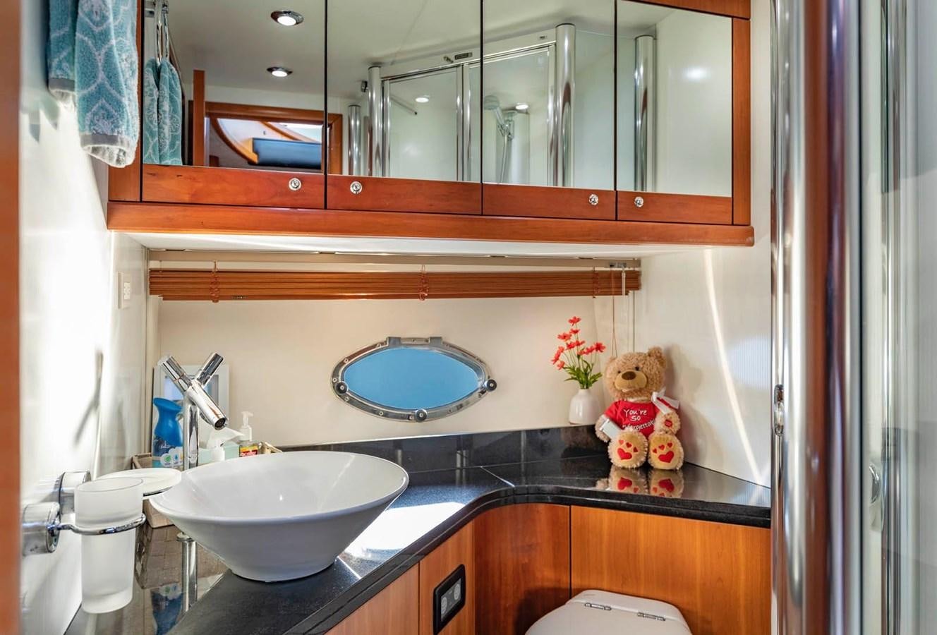 a bathroom with a sink and a mirror aboard UNFORGETTABLE Yacht for Sale