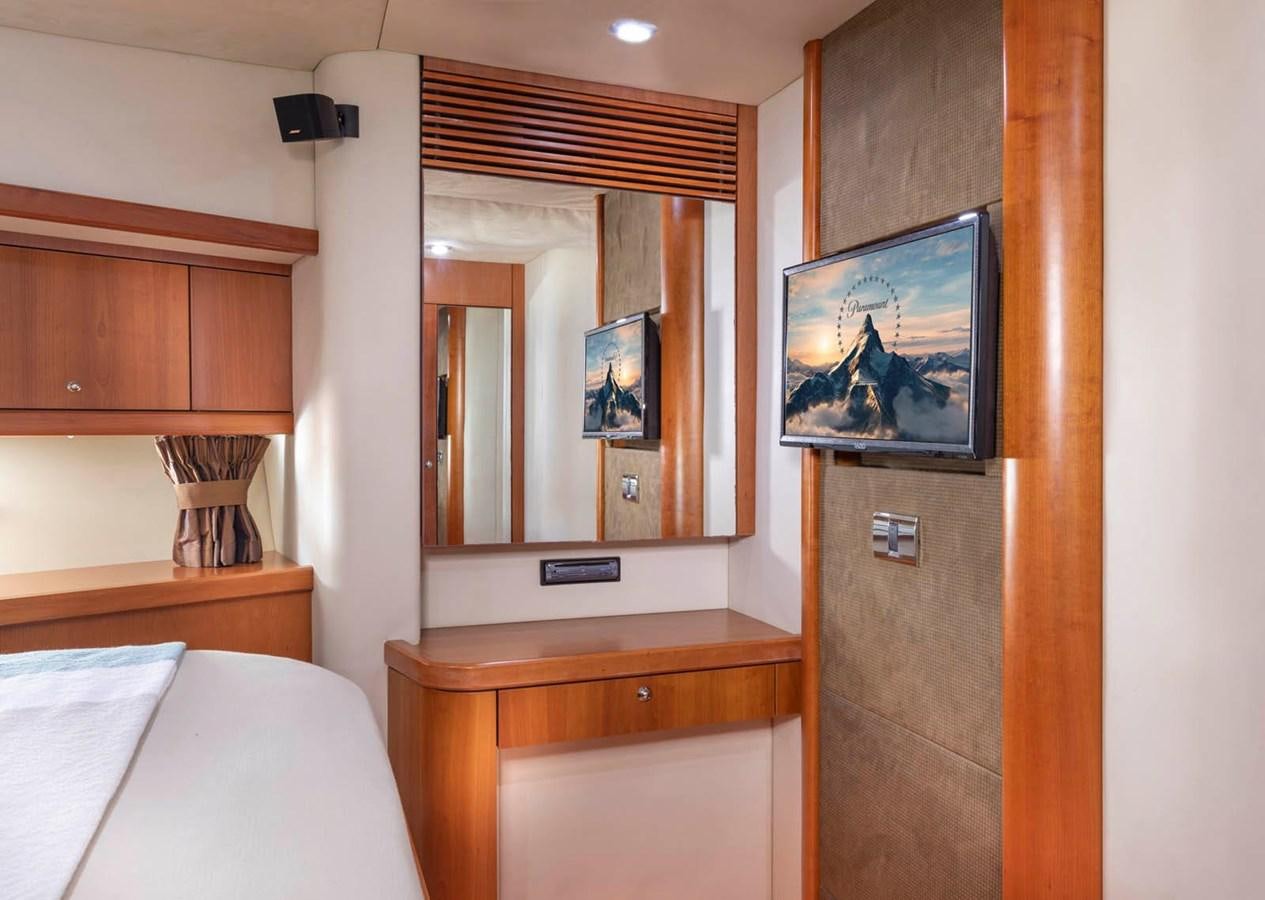 a room with a television and a bed aboard UNFORGETTABLE Yacht for Sale