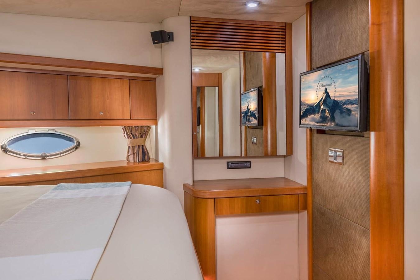 a room with a television and a bed aboard UNFORGETTABLE Yacht for Sale