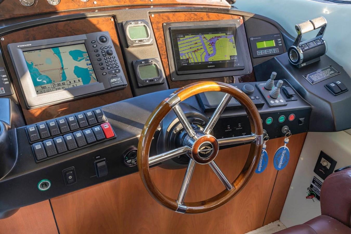 a console with a screen and buttons aboard UNFORGETTABLE Yacht for Sale
