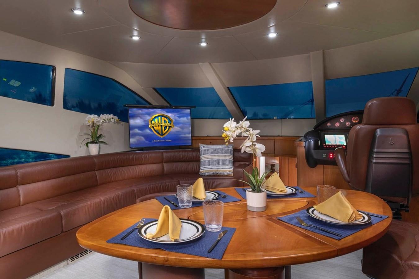 a restaurant with a table and chairs aboard UNFORGETTABLE Yacht for Sale