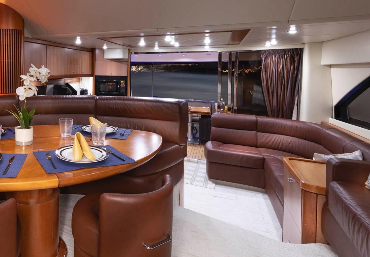 a room with a table and couches aboard UNFORGETTABLE Yacht for Sale