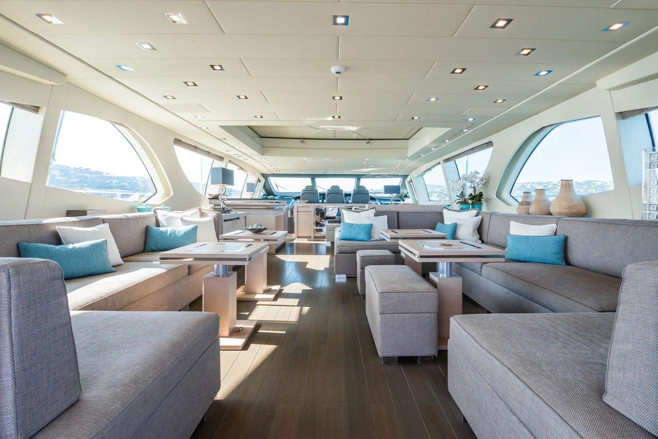 a room with a couch and a table and chairs aboard MANGUSTA 130 Yacht for Sale