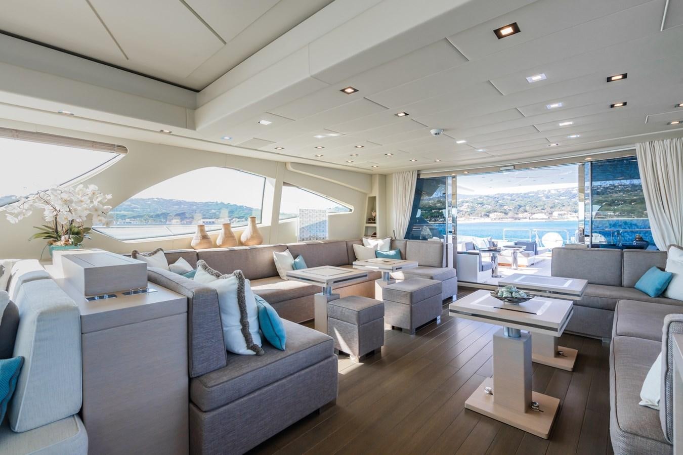 a living room with a large window aboard MANGUSTA 130 Yacht for Sale