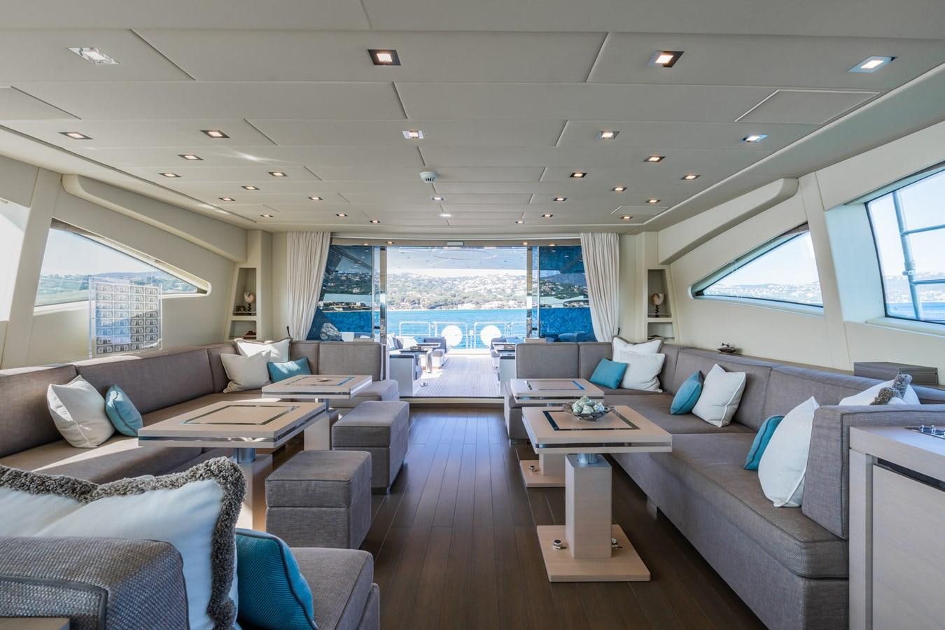 a living room with a large window aboard MANGUSTA 130 Yacht for Sale