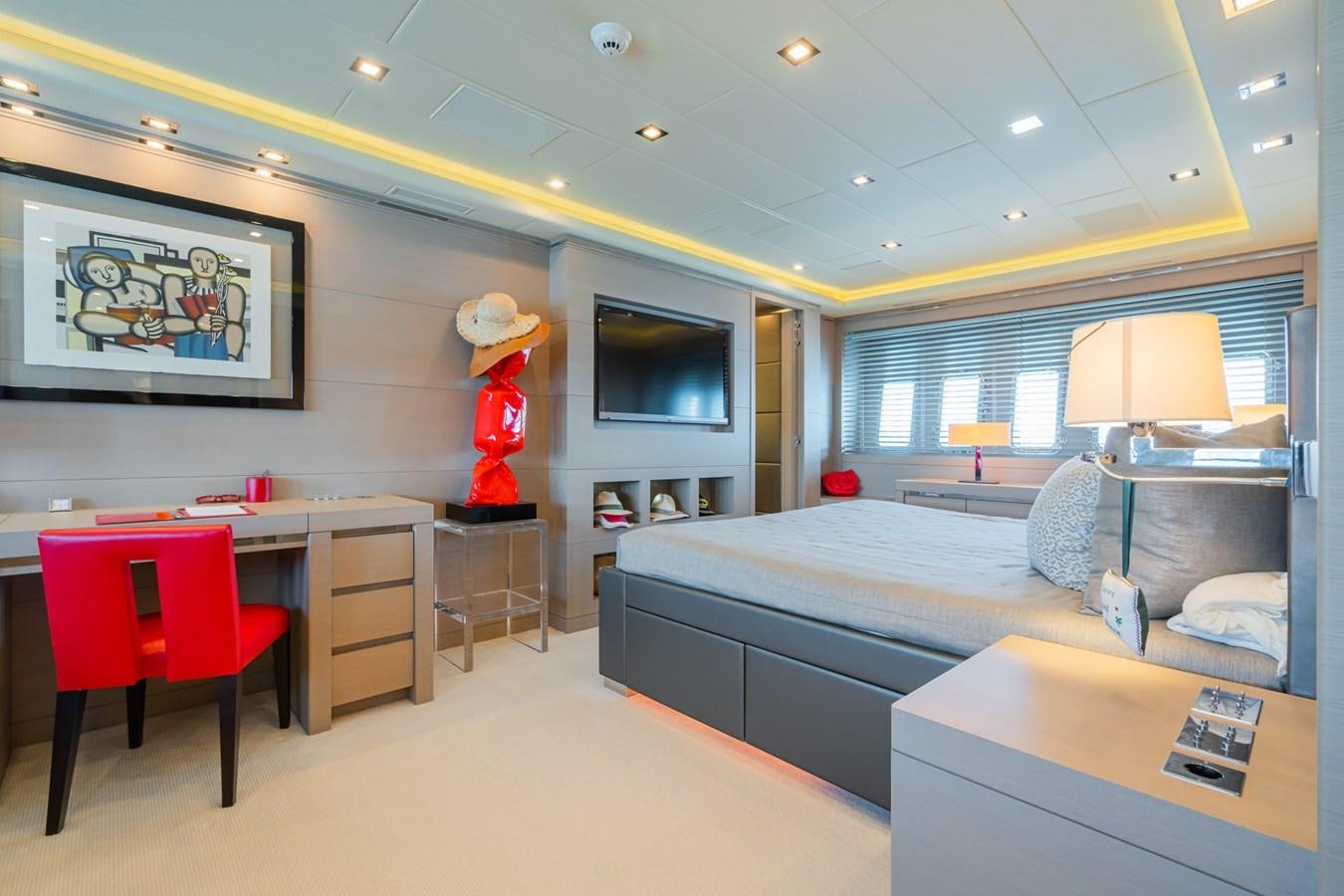 a bedroom with a bed and desk aboard MANGUSTA 130 Yacht for Sale