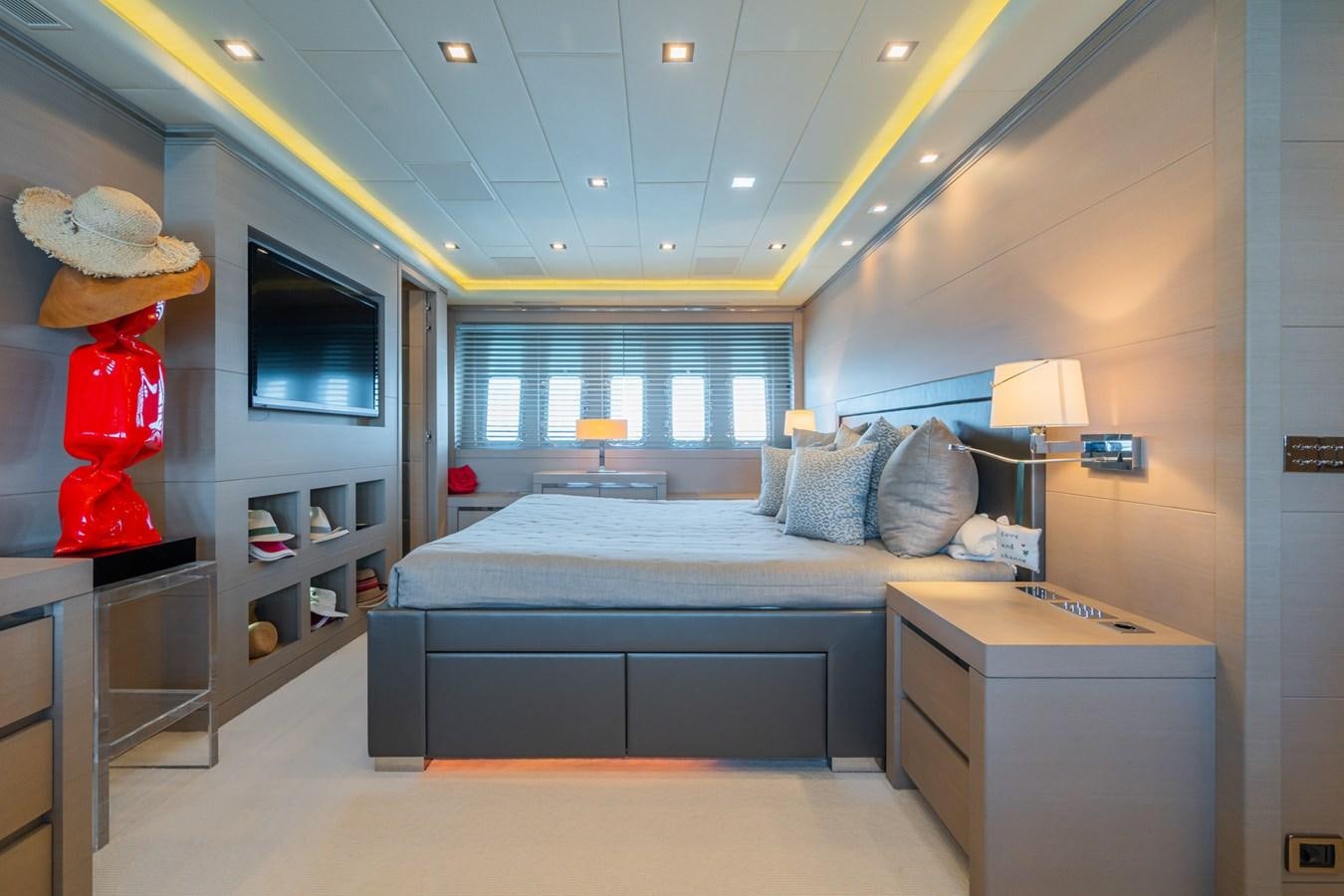 a bedroom with a bed and a desk aboard MANGUSTA 130 Yacht for Sale
