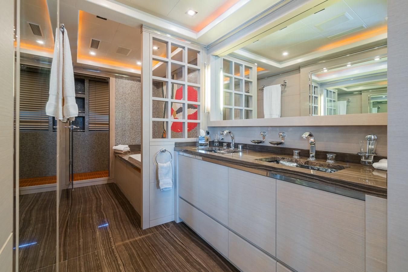 a bathroom with a sink and a mirror aboard MANGUSTA 130 Yacht for Sale