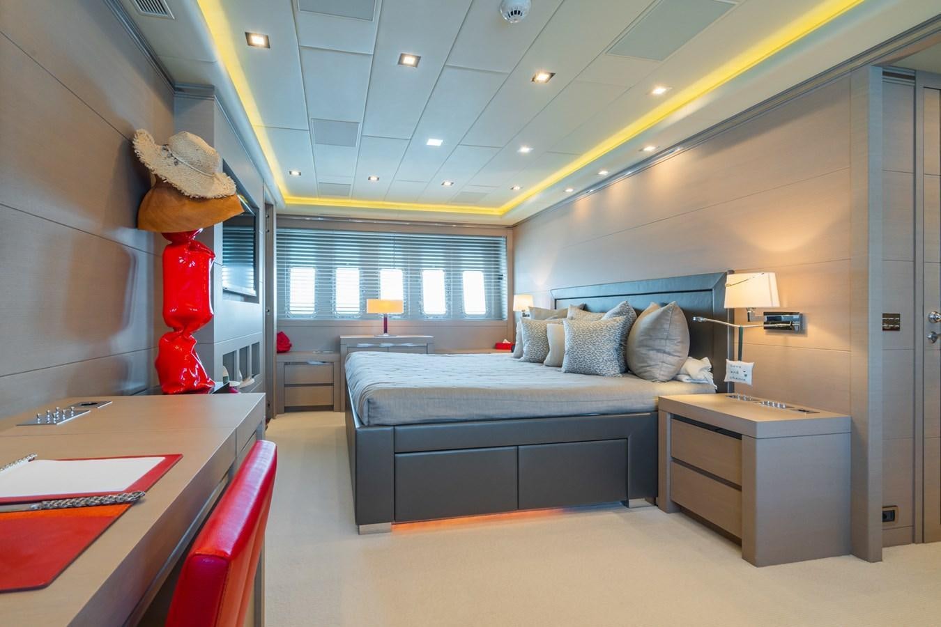 a bedroom with a bed and a desk aboard MANGUSTA 130 Yacht for Sale