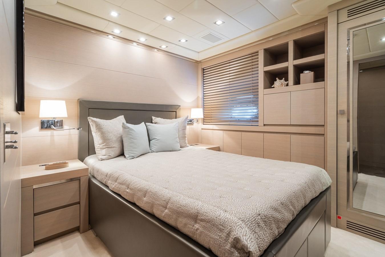 a bedroom with a bed and a desk aboard MANGUSTA 130 Yacht for Sale