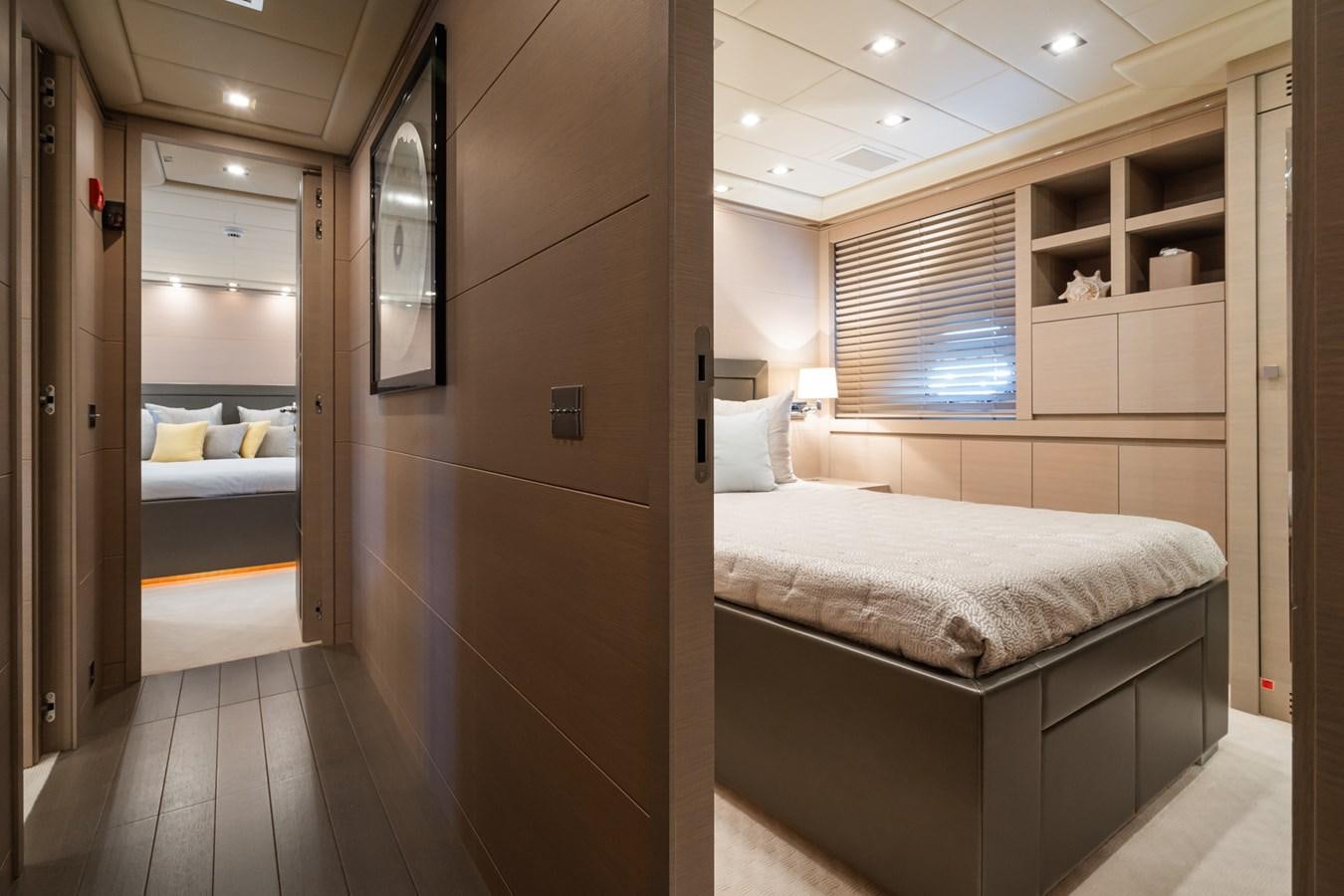 a room with a bed and a mirror aboard MANGUSTA 130 Yacht for Sale