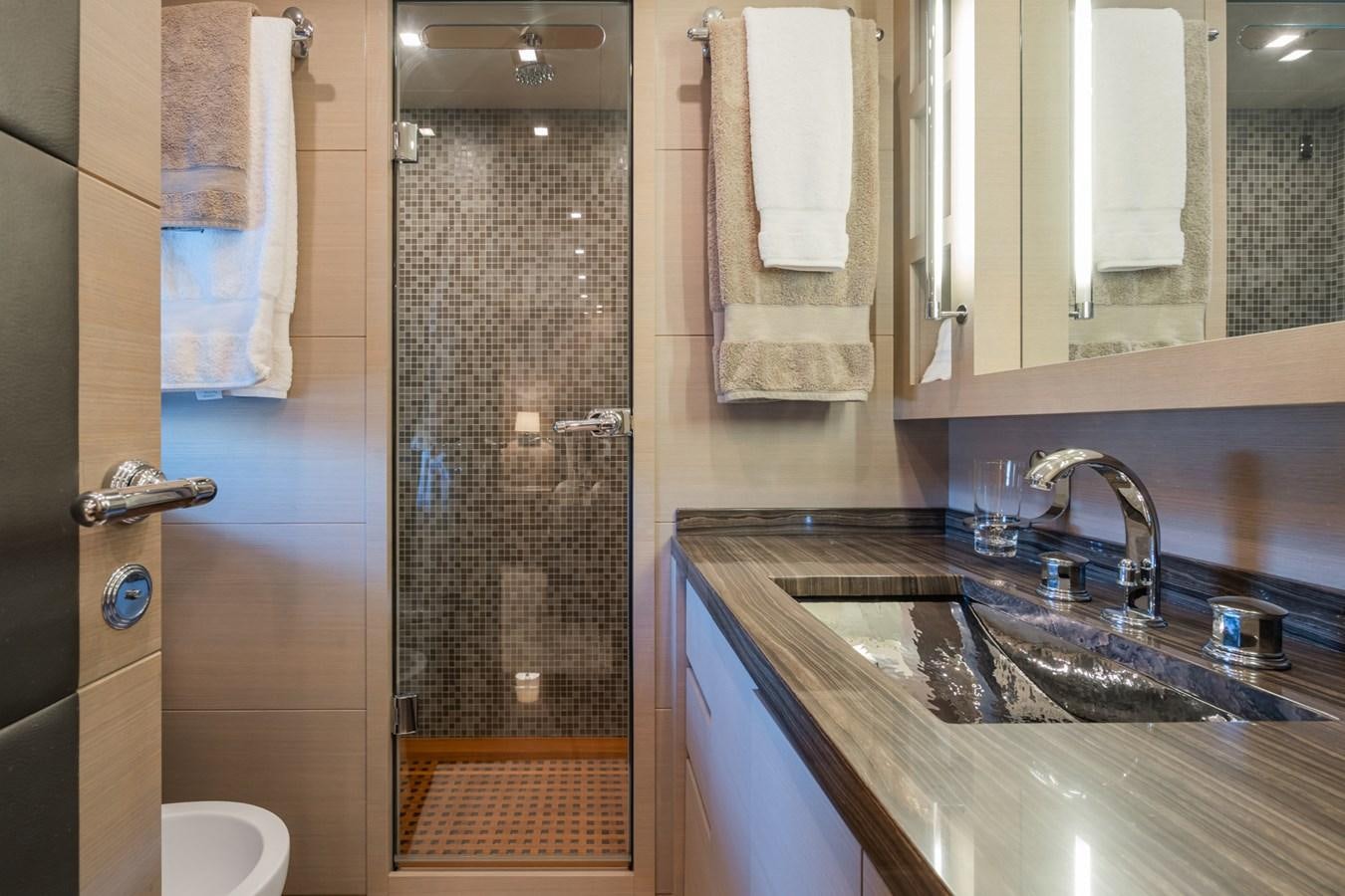 a bathroom with a shower and sink aboard MANGUSTA 130 Yacht for Sale
