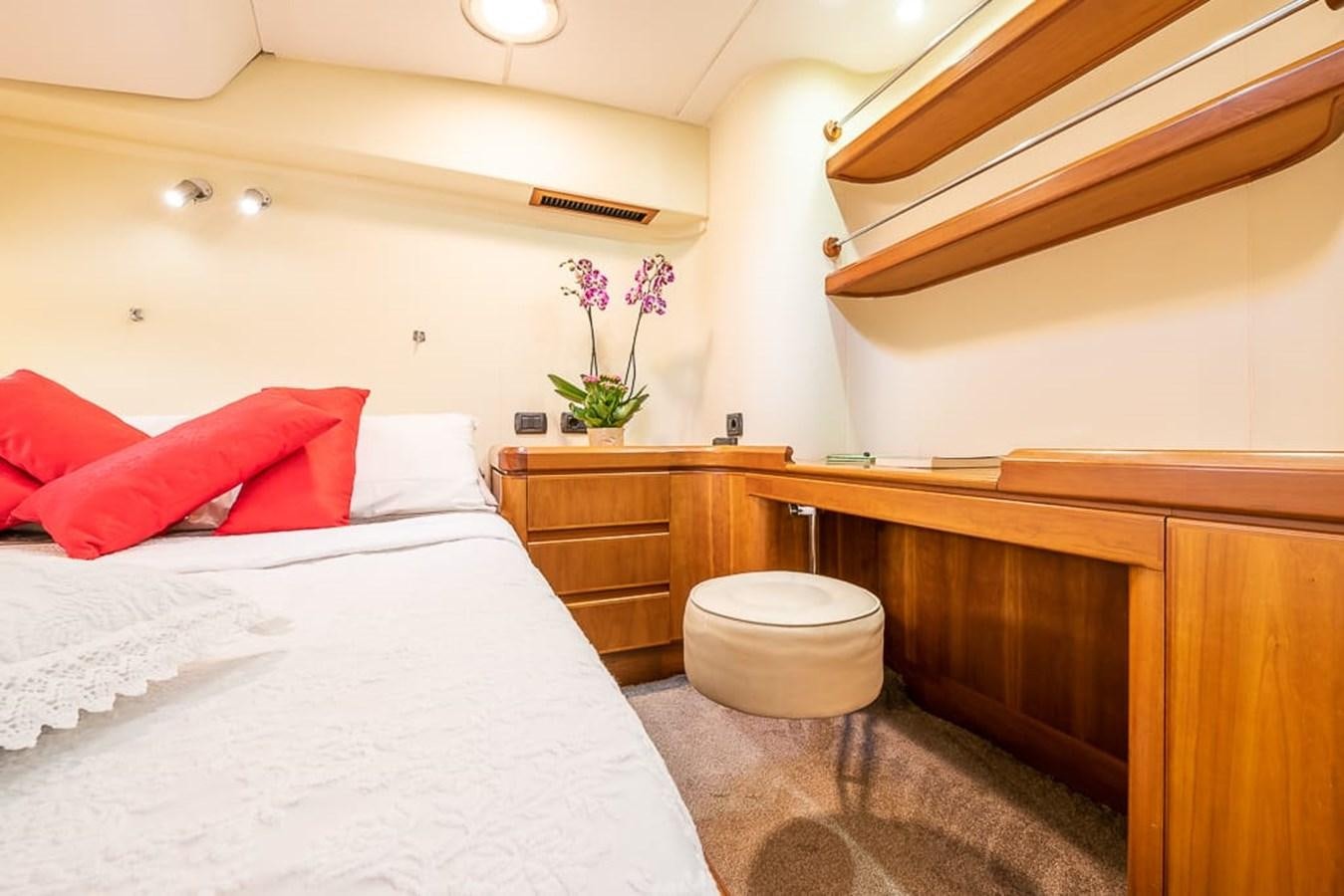 a bed with pink pillows aboard OCEAN PHOENIX Yacht for Sale