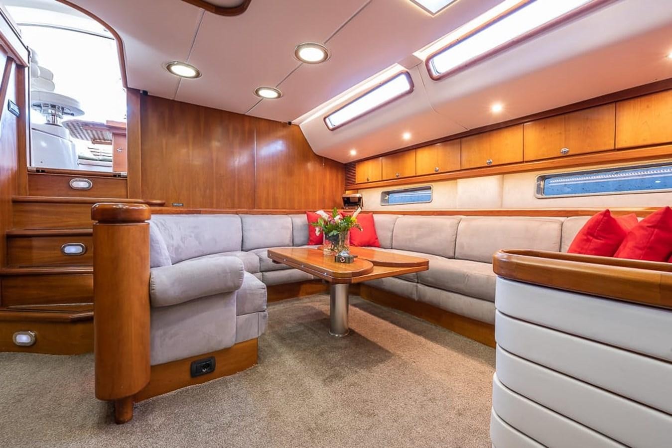 a living room with a couch and a coffee table aboard OCEAN PHOENIX Yacht for Sale