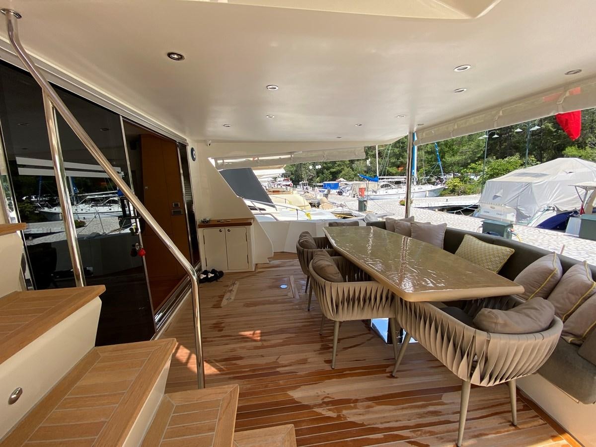 a room with a couch and a table and chairs aboard MR CORN Yacht for Sale