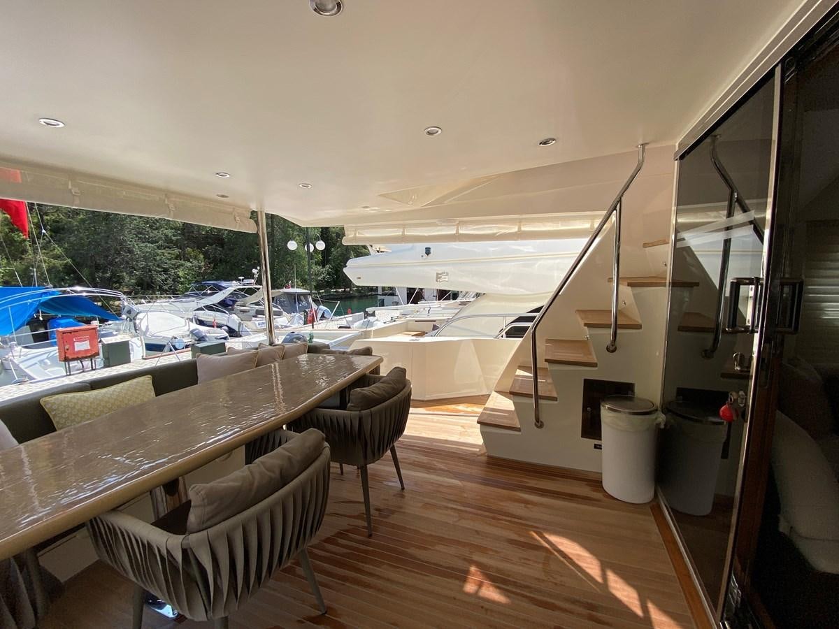 a room with a table and chairs aboard MR CORN Yacht for Sale