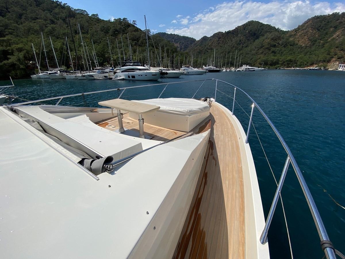 a boat in the water with Shasta Lake in the background aboard MR CORN Yacht for Sale