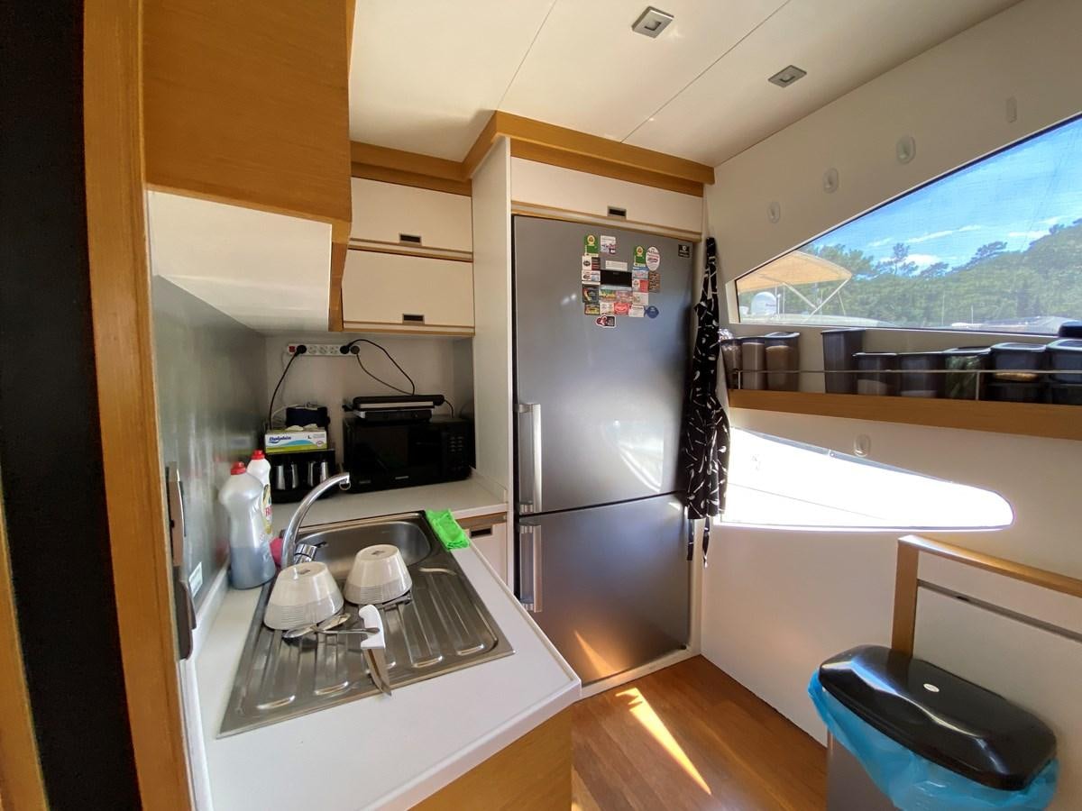 a kitchen with a large screen aboard MR CORN Yacht for Sale