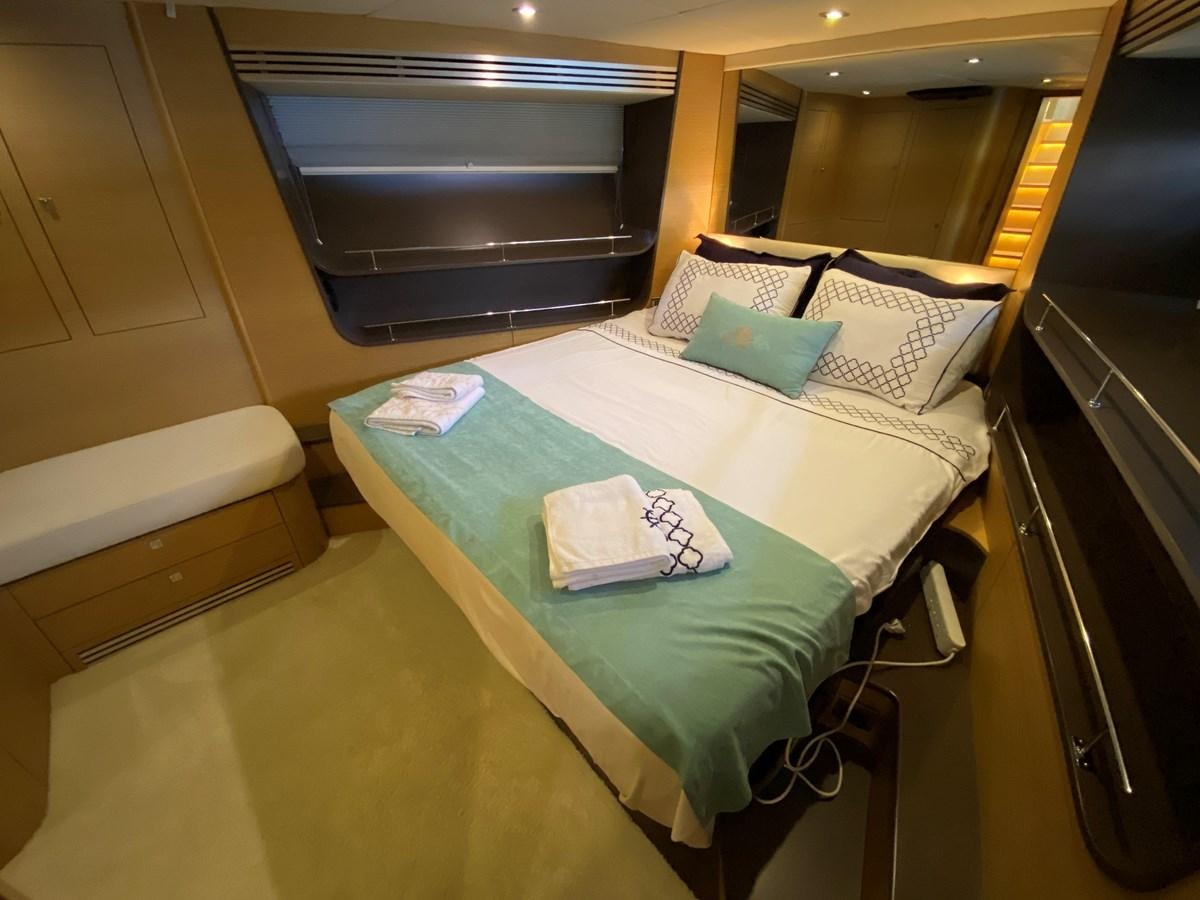 a bed with a green sheet aboard MR CORN Yacht for Sale