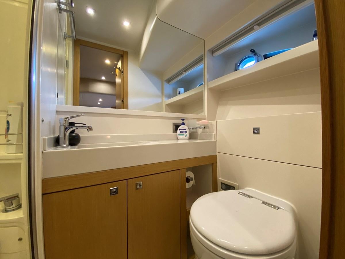 a bathroom with a toilet and a sink aboard MR CORN Yacht for Sale