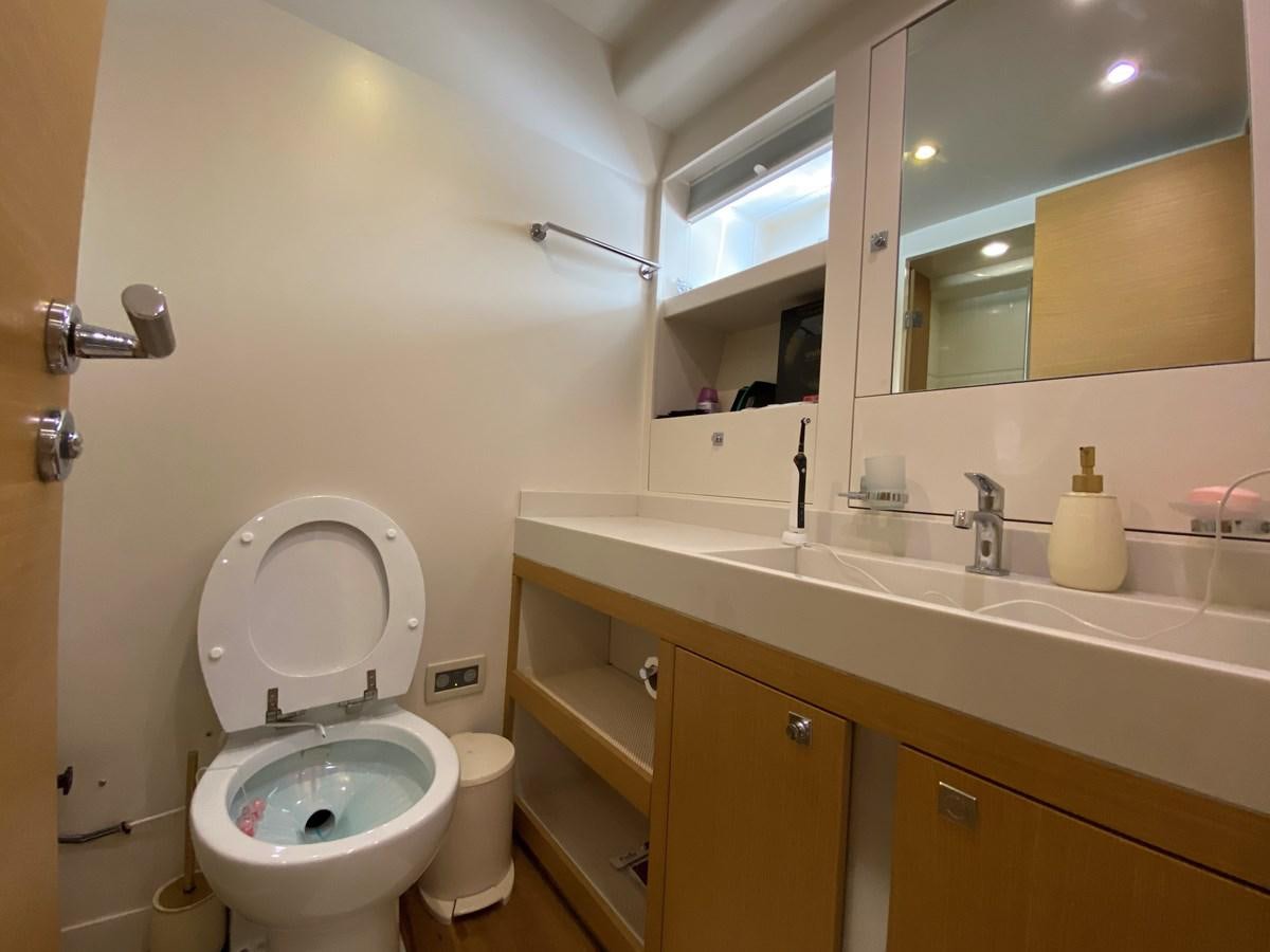 a bathroom with a toilet and a sink aboard MR CORN Yacht for Sale