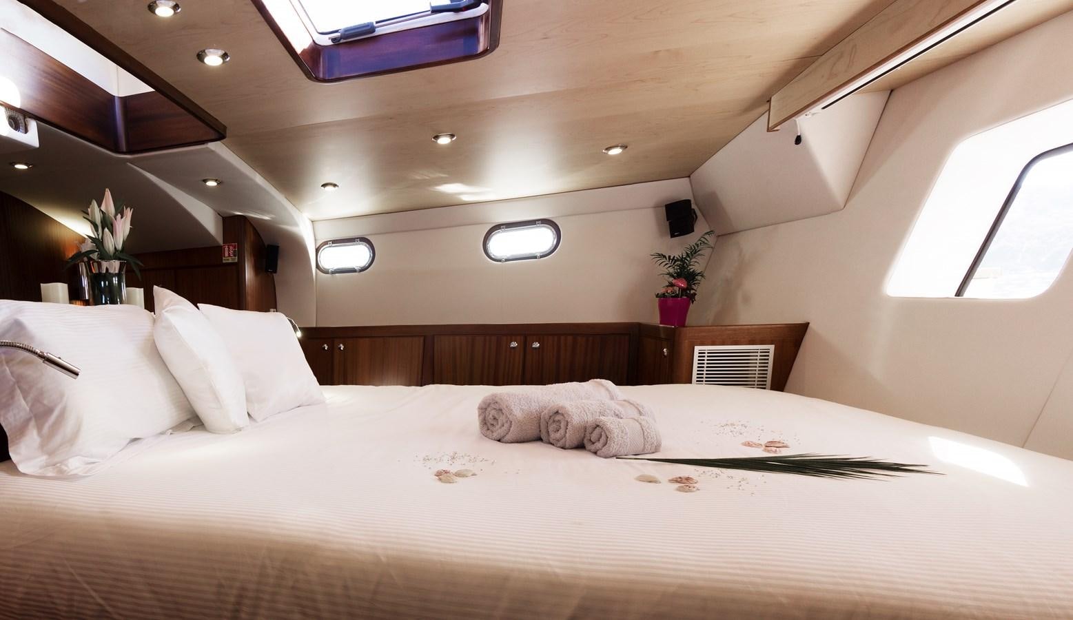 a bed with white sheets aboard LADY FLORE Yacht for Sale
