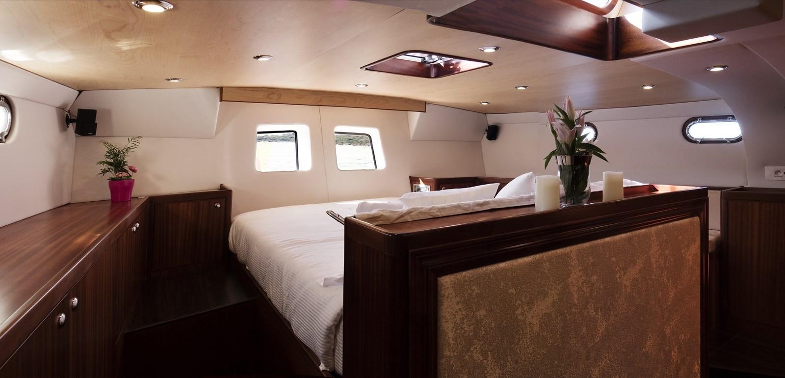 a room with a bed and a plant on the wall aboard LADY FLORE Yacht for Sale