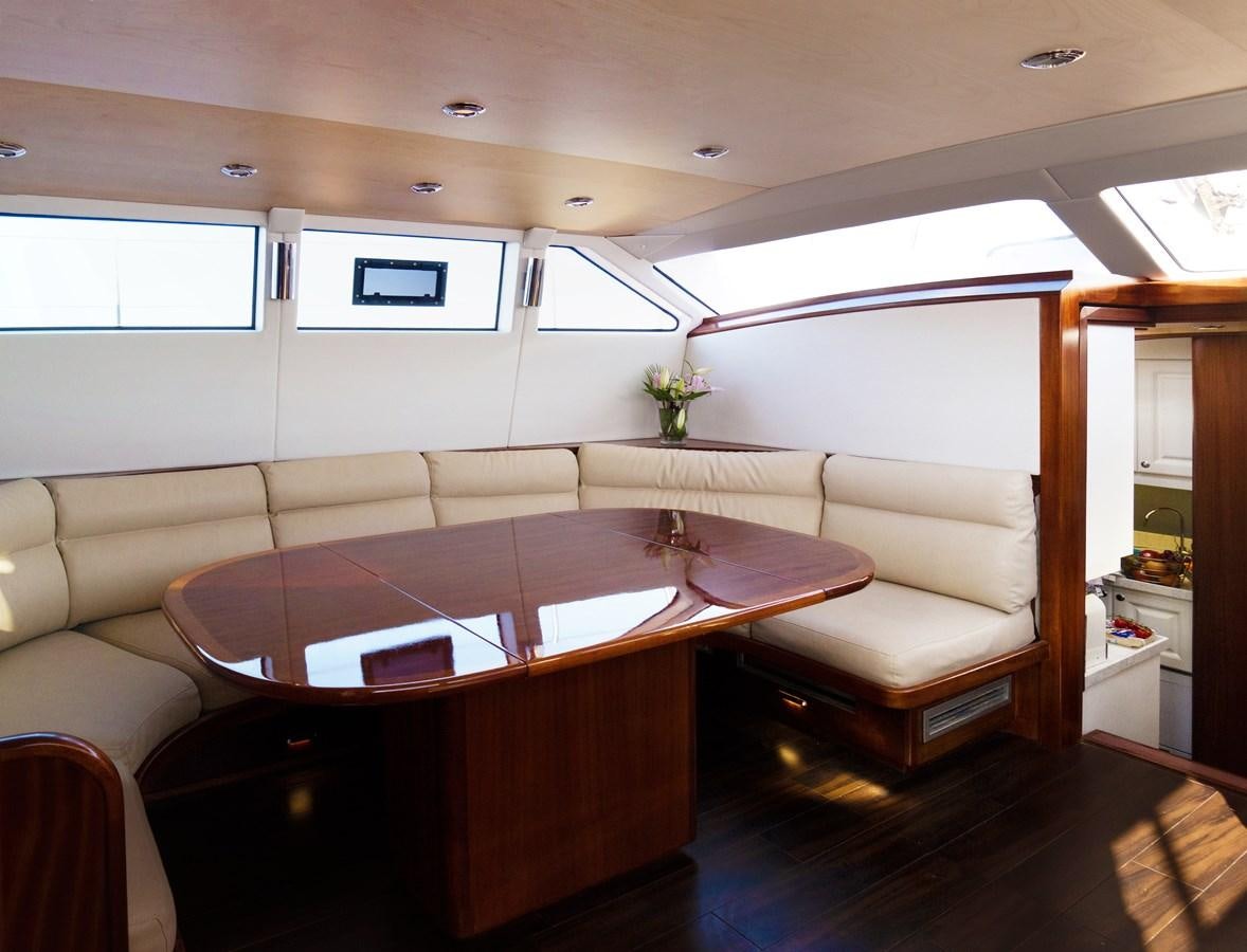 a room with a table and chairs aboard LADY FLORE Yacht for Sale
