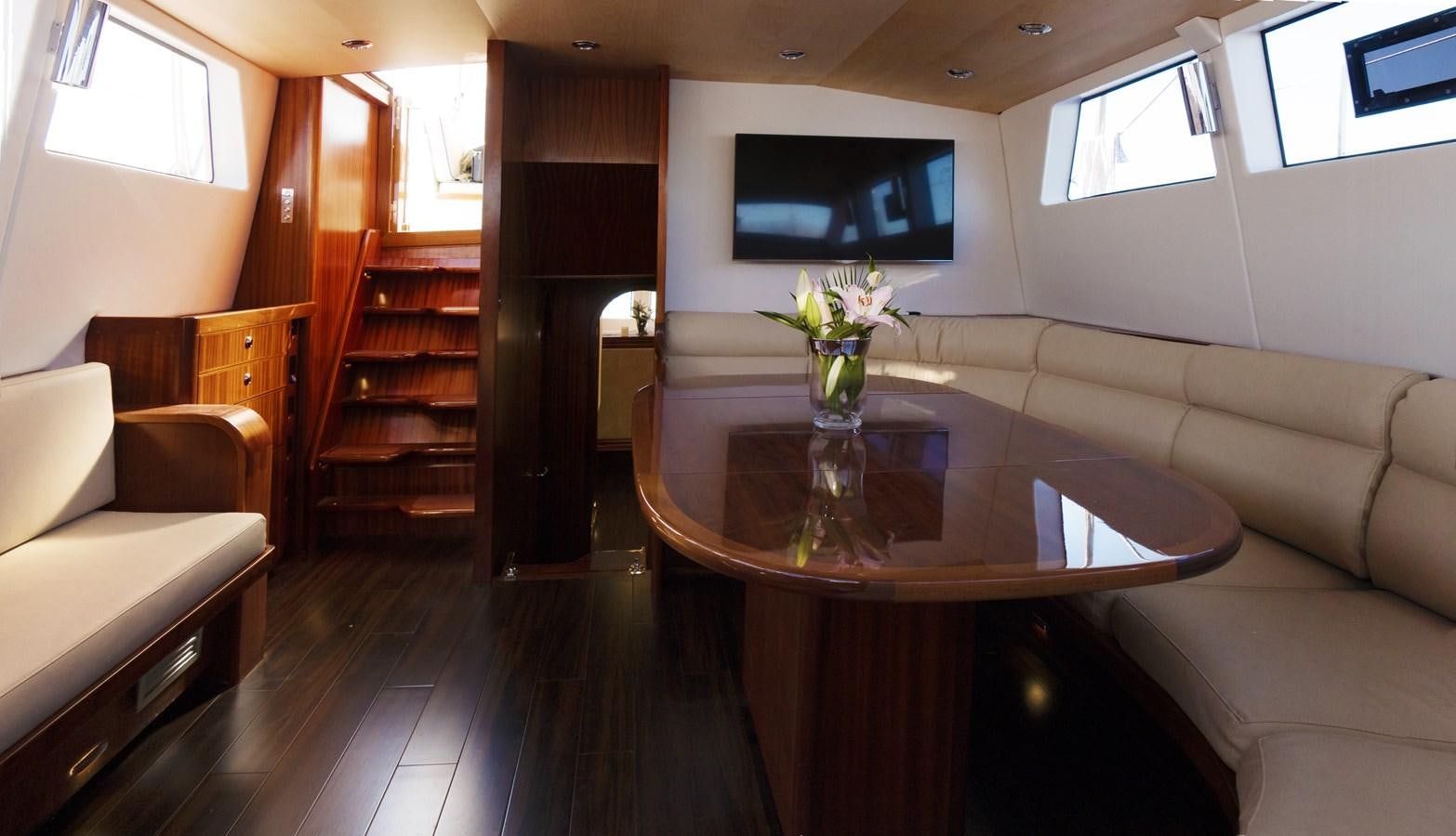 a living room with a table and couches aboard LADY FLORE Yacht for Sale