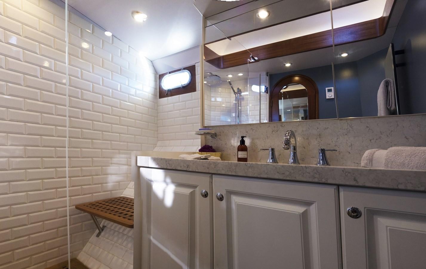 a bathroom with a sink and a mirror aboard LADY FLORE Yacht for Sale