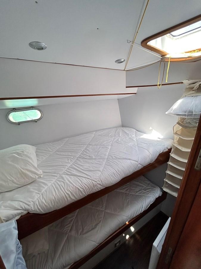 a bed with white sheets aboard LADY FLORE Yacht for Sale