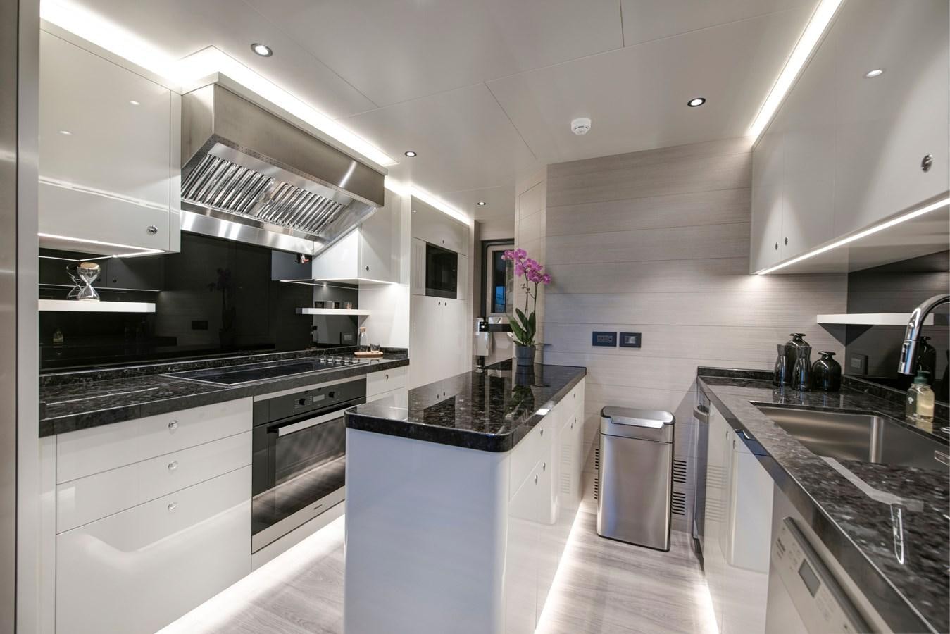 a kitchen with white cabinets aboard PICCOLO @ FLIBS Yacht for Sale