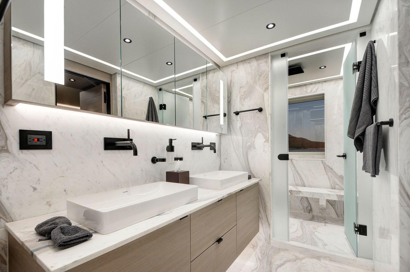 a bathroom with a sink and a mirror aboard PICCOLO @ FLIBS Yacht for Sale