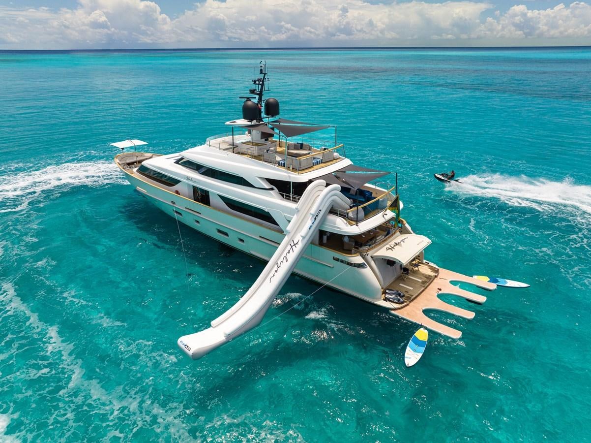 a helicopter flying over a boat in the ocean aboard HALCYON Yacht for Sale