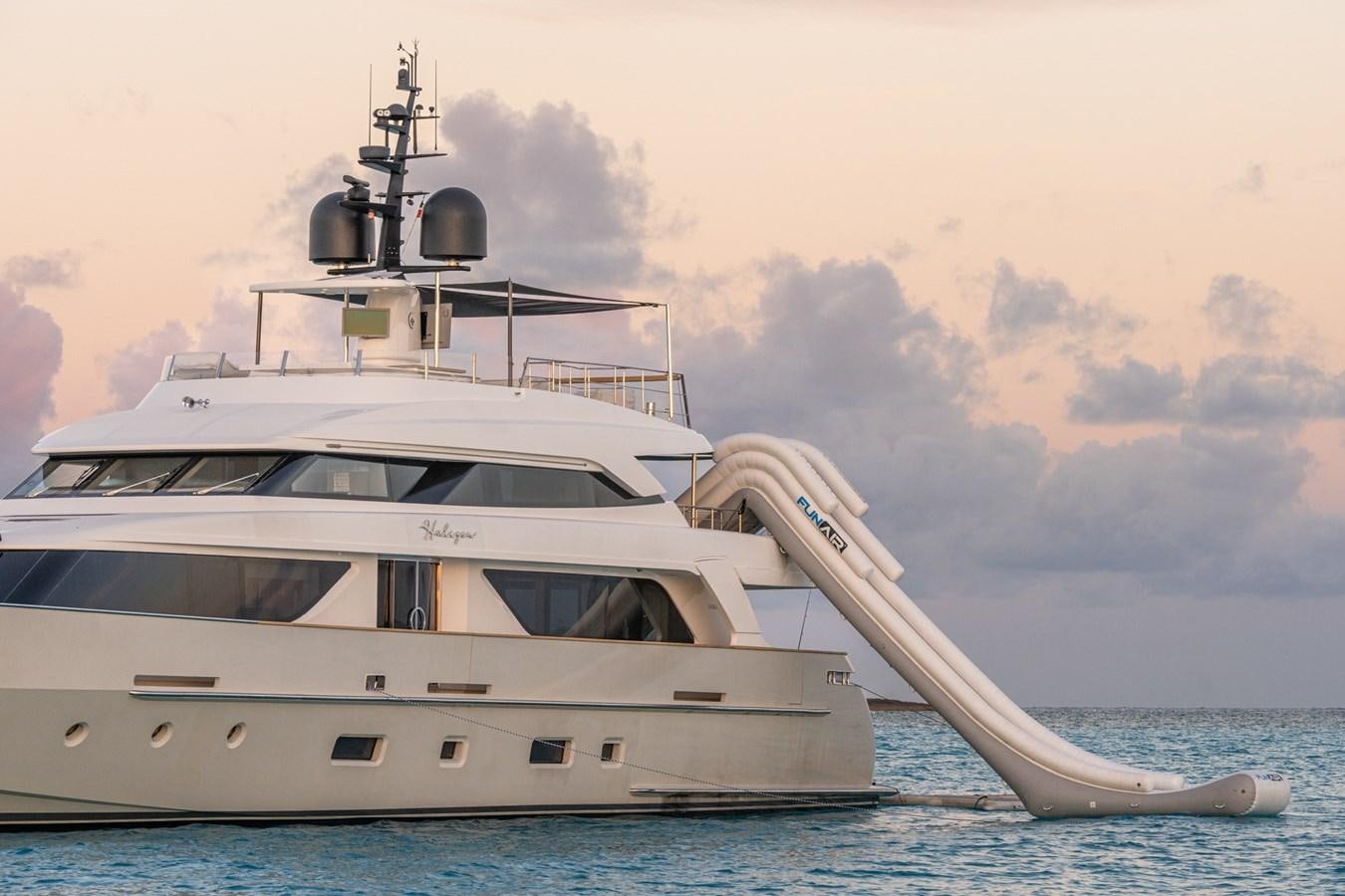 a white yacht with a large antenna on top of it aboard HALCYON Yacht for Sale
