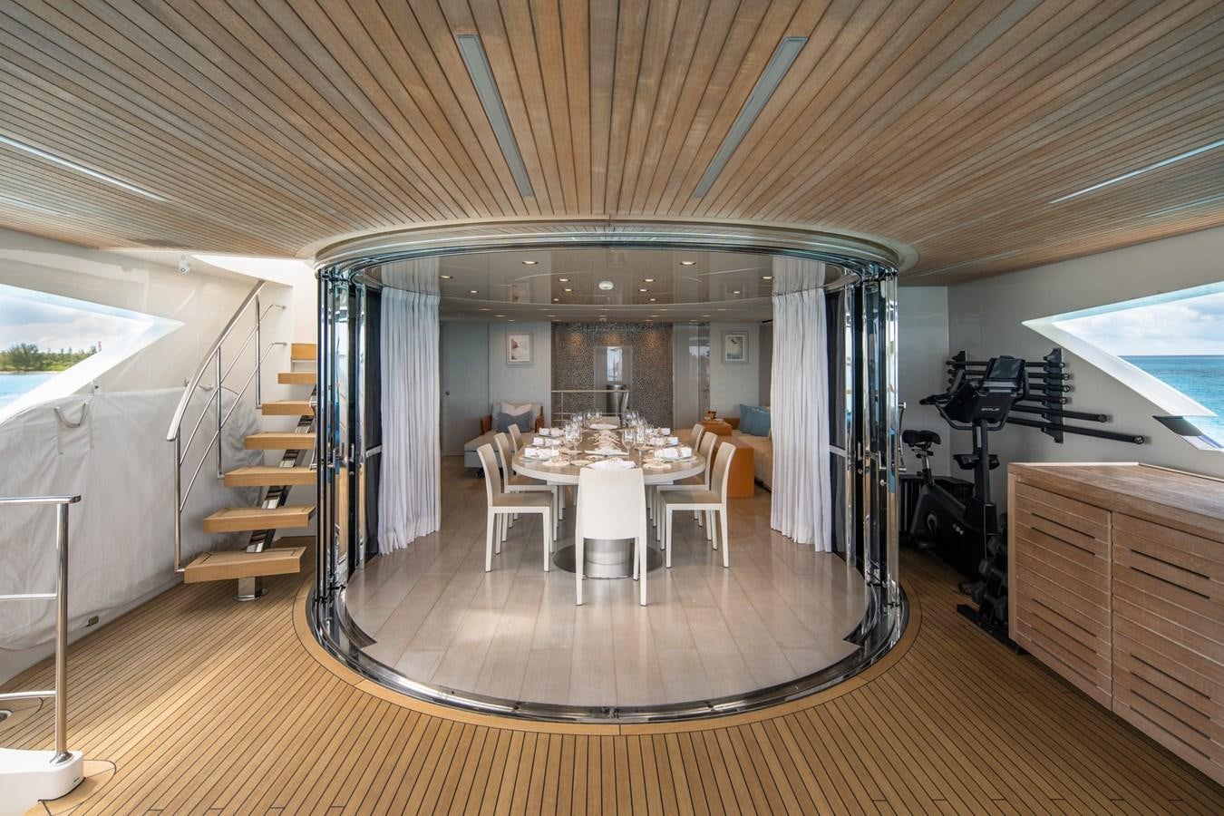 a room with tables and chairs aboard HALCYON Yacht for Sale