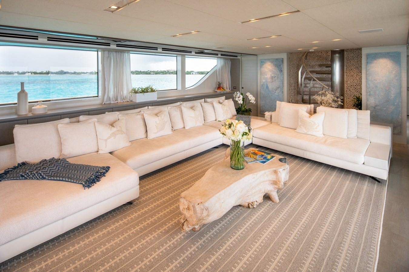 a living room with a large sofa and a large window aboard HALCYON Yacht for Sale