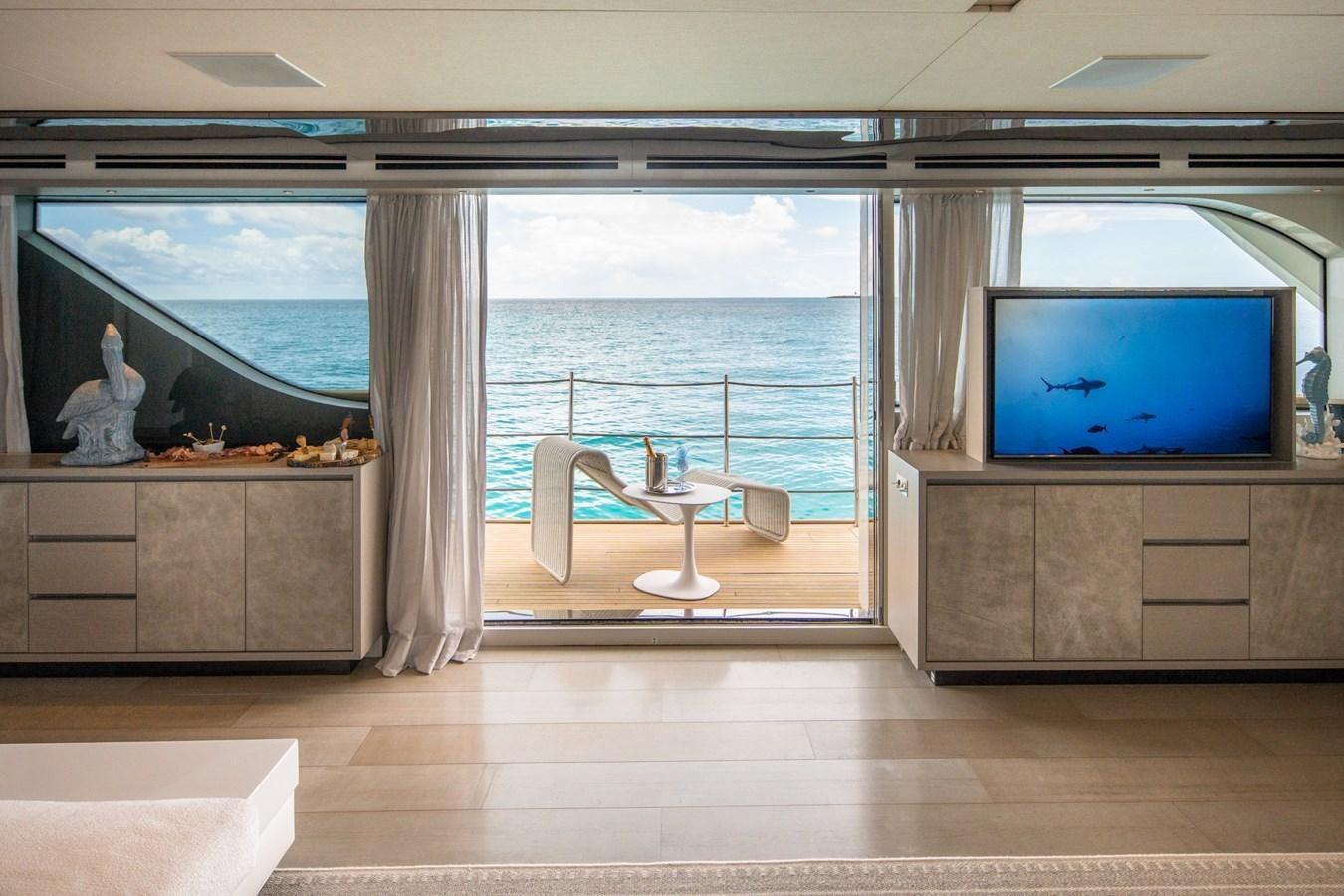 a room with a tv and a table aboard HALCYON Yacht for Sale