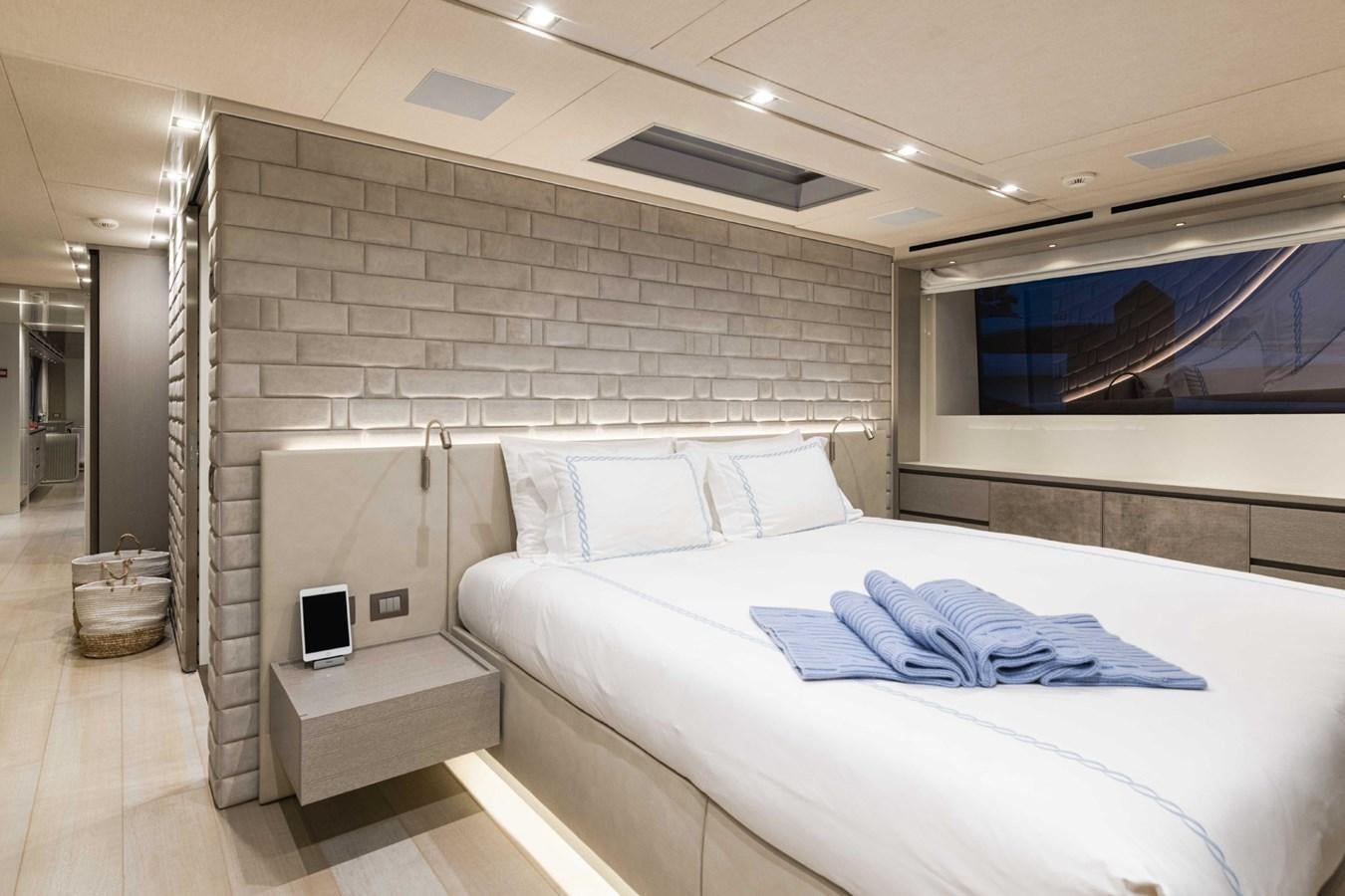 a room with a bed and a television aboard HALCYON Yacht for Sale