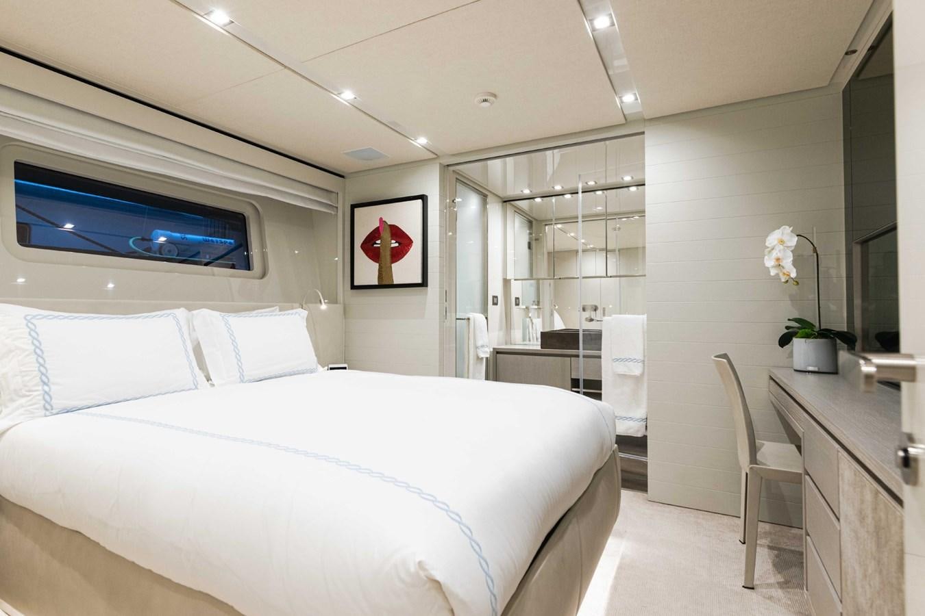 a bedroom with a bed and a tv on the wall aboard HALCYON Yacht for Sale