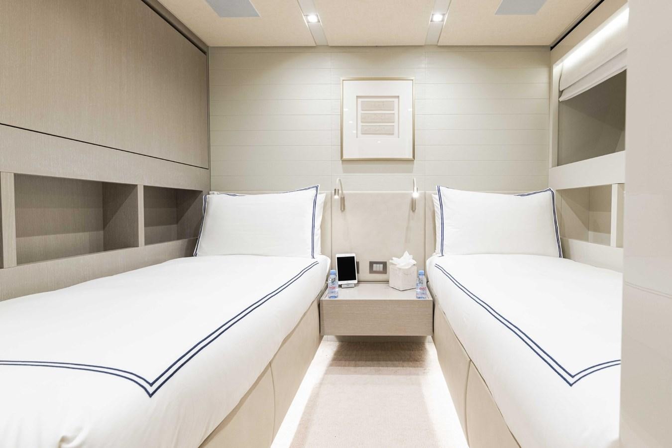 a room with beds and a mirror aboard HALCYON Yacht for Sale
