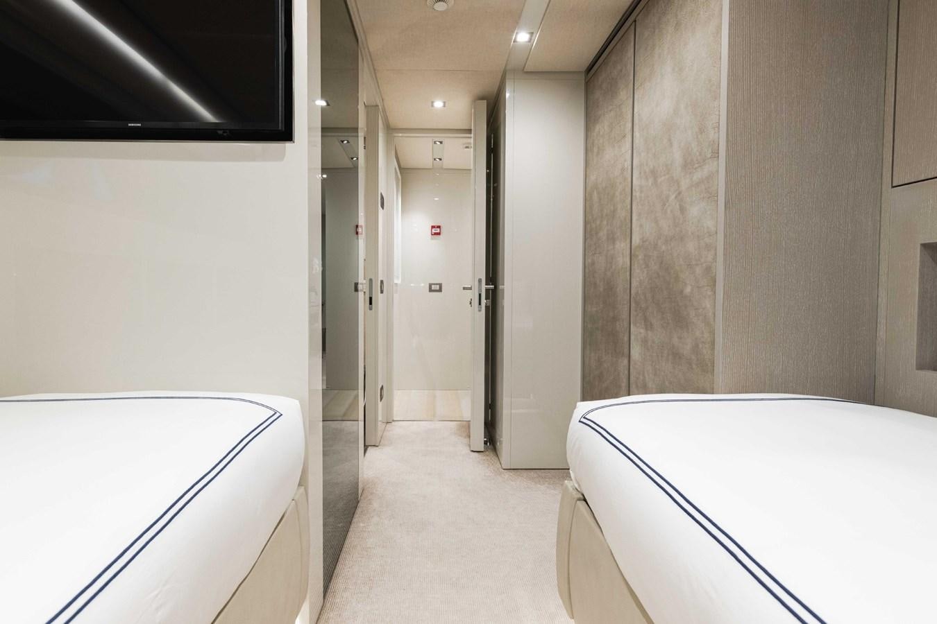 a hallway with a desk and a bed aboard HALCYON Yacht for Sale