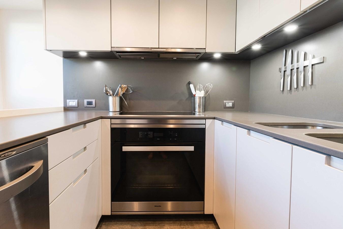 a kitchen with white cabinets aboard HALCYON Yacht for Sale