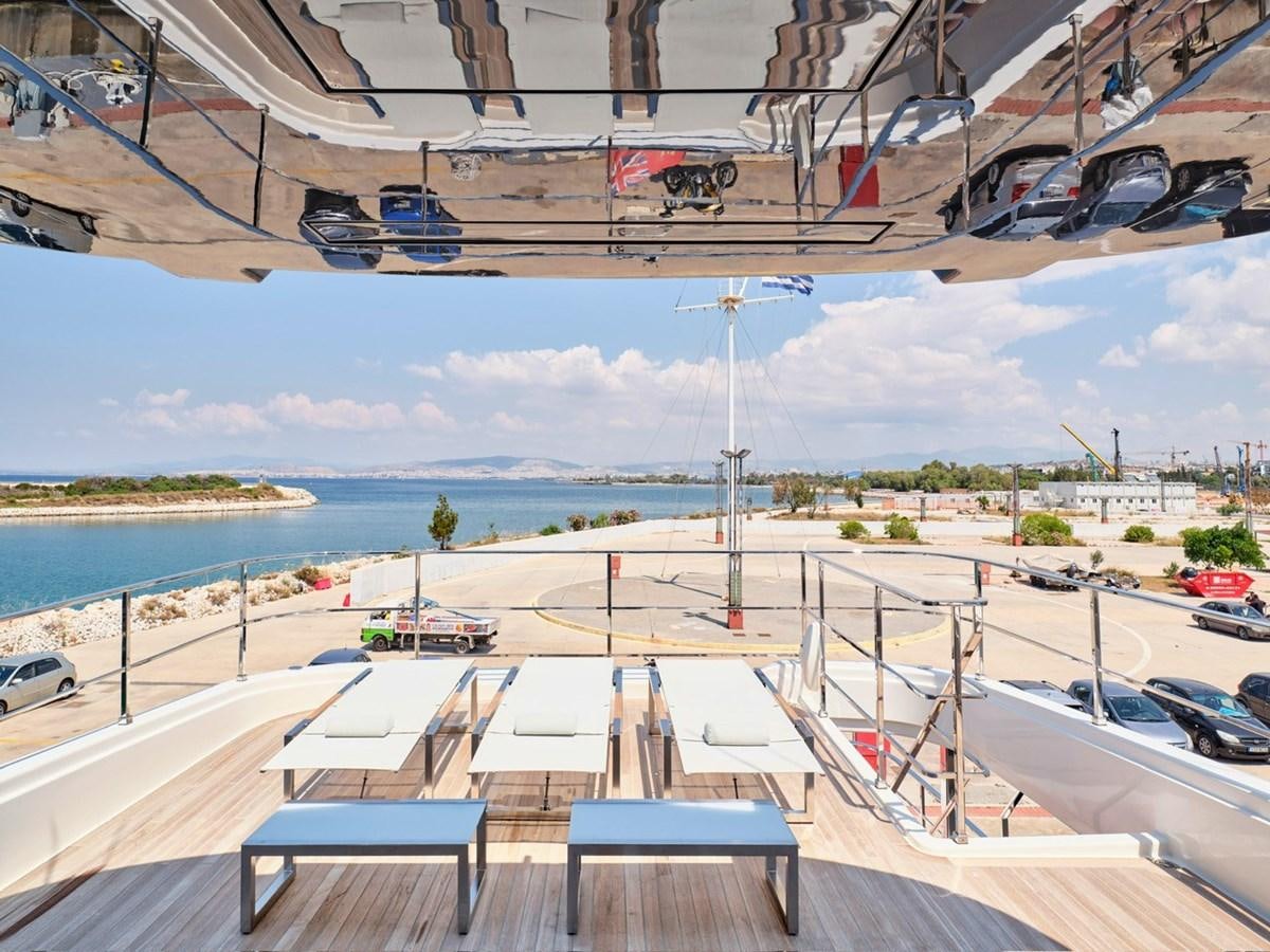 a parking lot with cars and a parking lot with a body of water in the background aboard "THIRTY SEVEN Yacht for Sale