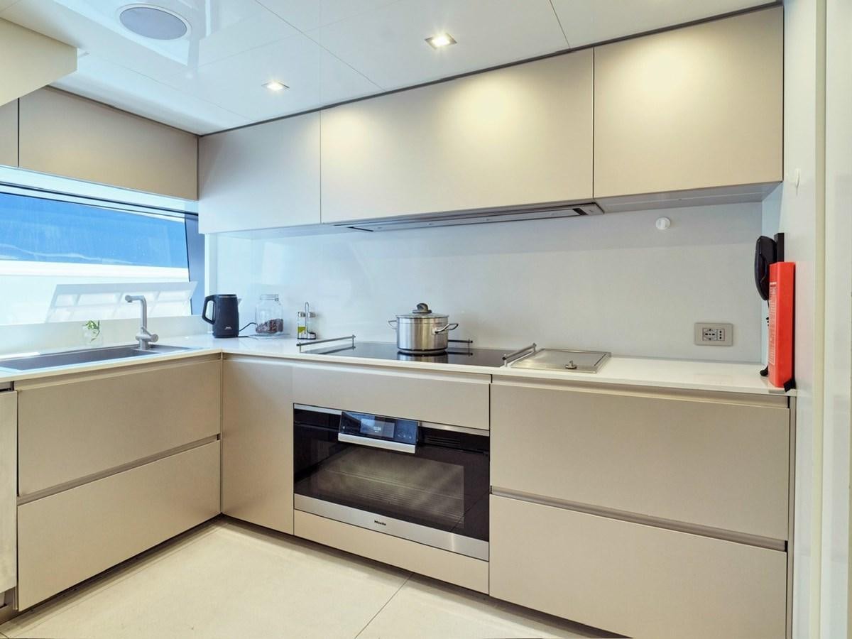 a kitchen with white cabinets aboard "THIRTY SEVEN Yacht for Sale