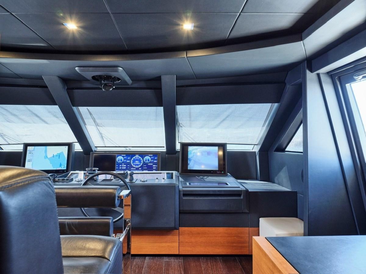inside of a vehicle with a screen and a desk with chairs and a window with a window and aboard "THIRTY SEVEN Yacht for Sale