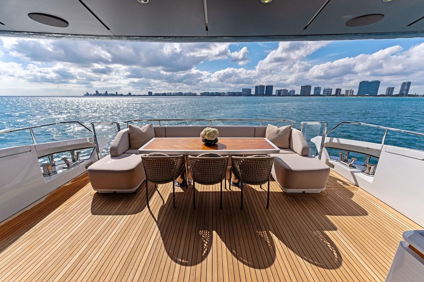 a table and chairs on a deck overlooking a large body of water aboard LADY K Yacht for Sale